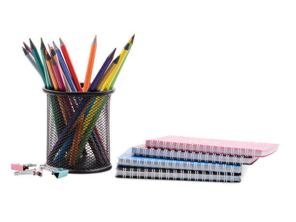 istock Several notebooks and colored pencils in a cup and several clips for papers. The concept of education. 904564678