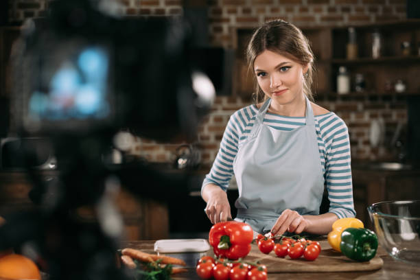 istock young food blogger cutting cherry tomatoes 904564834