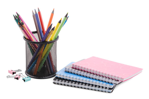istock A stack of notebooks, colored pencils in a black cup and several clips for papers. The concept of education. 904564872