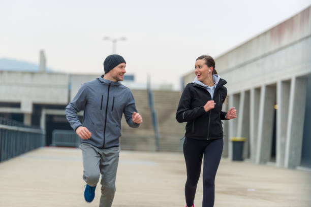 istock Young couple running together 904567120
