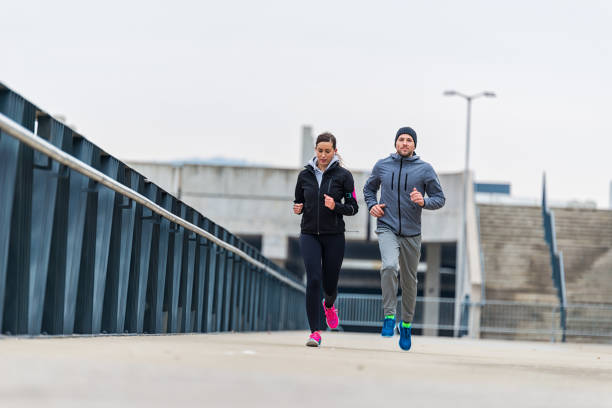 istock Young couple running together 904567124