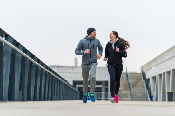 istock Young couple running together 904568168