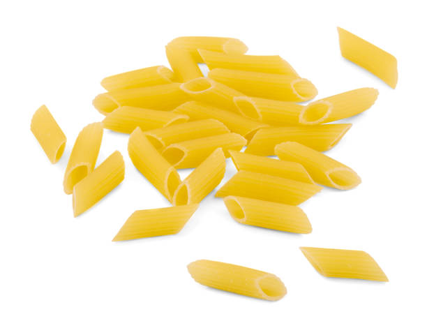 istock Heap of raw macaroni. Close-up. Isolated on white background. 904569154