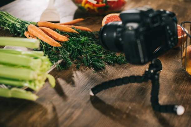 istock digital camera and vegetables on wooden table 904571102