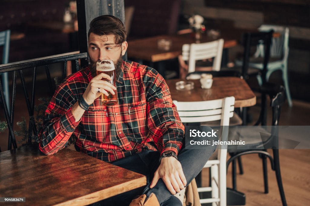 Young bearded man drinking beer Beer - Alcohol Stock Photo