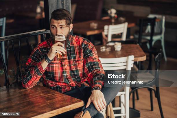 Young Bearded Man Drinking Beer Stock Photo - Download Image Now - Beer - Alcohol, Drinking, Bar - Drink Establishment