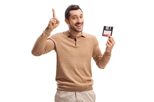 istock Young man with a floppy disk holding his index finger up 904586556