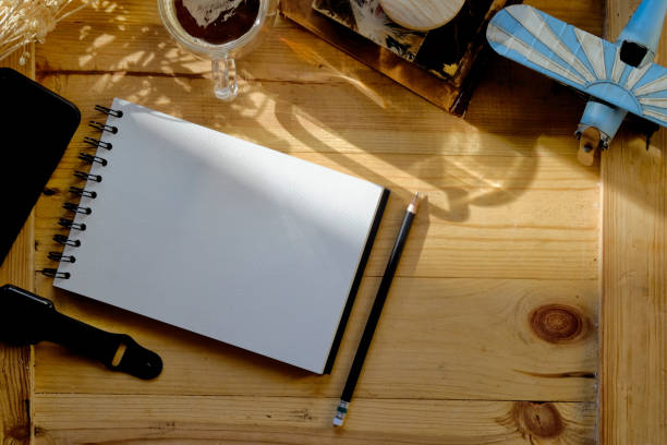 istock View from above with notebook, wood table with mobile phone, toy and coffee mug. 904586932