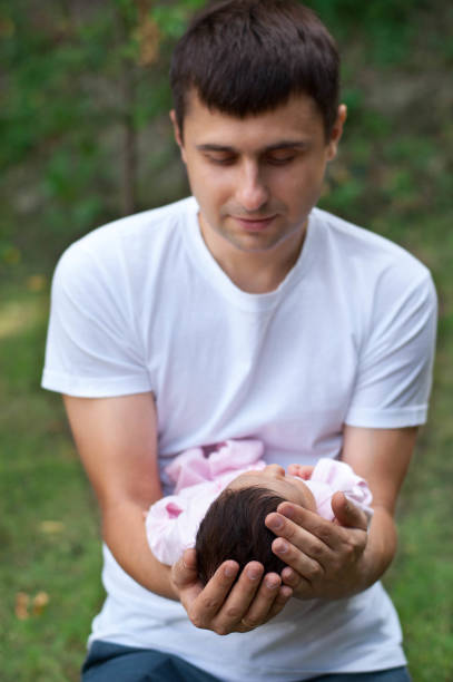 istock Father is holding his newborn baby. Birth concept 904590238