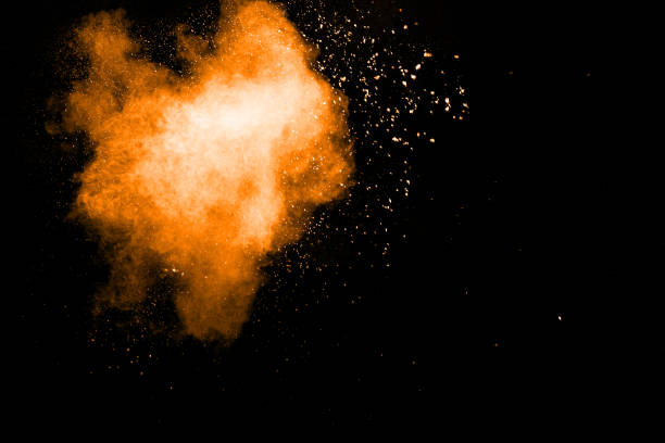 istock abstract orange powder explosion on black background. abstract orange dust splattered on  black background. Freeze motion of orange powder splash. 904593516