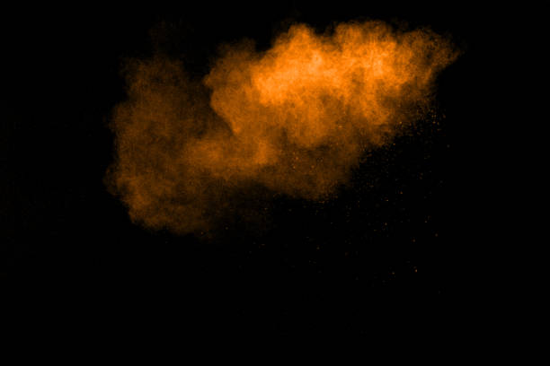 istock abstract orange powder explosion on black background. abstract orange dust splattered on  black background. Freeze motion of orange powder splash. 904593544