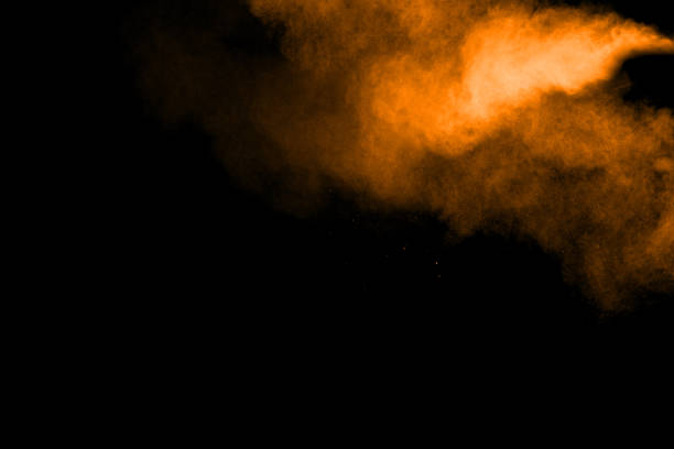 istock abstract orange powder explosion on black background. abstract orange dust splattered on  black background. Freeze motion of orange powder splash. 904593566