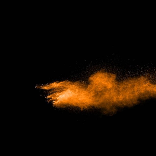 istock abstract orange powder explosion on black background. abstract orange dust splattered on  black background. Freeze motion of orange powder splash. 904593568
