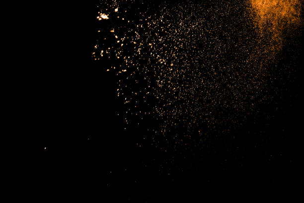 istock abstract orange powder explosion on black background. abstract orange dust splattered on  black background. Freeze motion of orange powder splash. 904593576