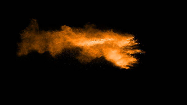 istock abstract orange powder explosion on black background. abstract orange dust splattered on  black background. Freeze motion of orange powder splash. 904593582