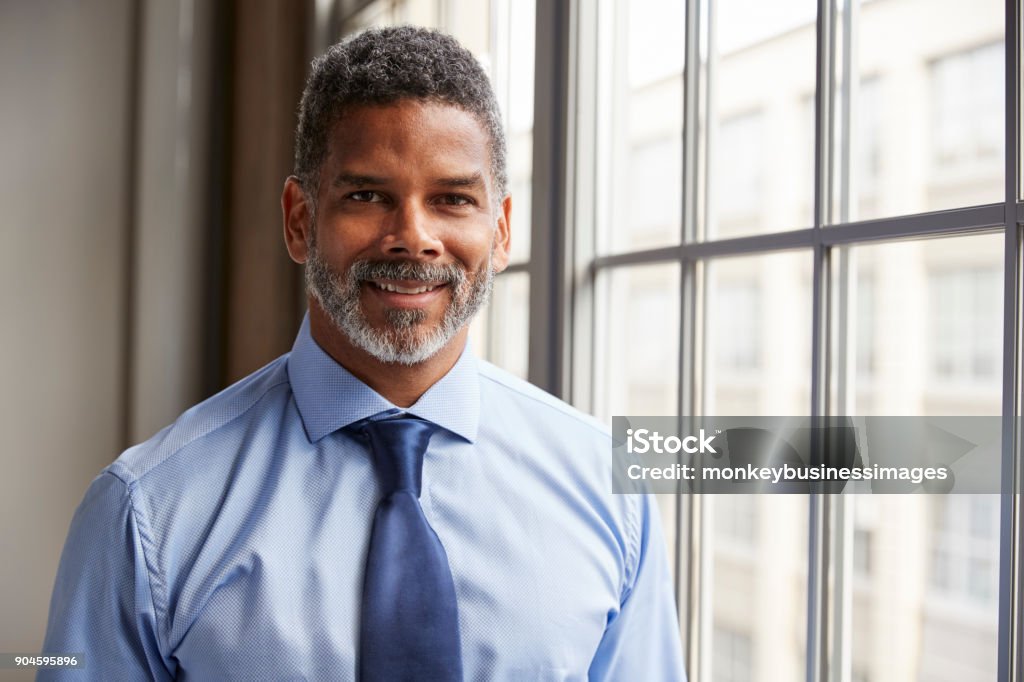 Middle aged black businessman smiling to camera Headshot Stock Photo