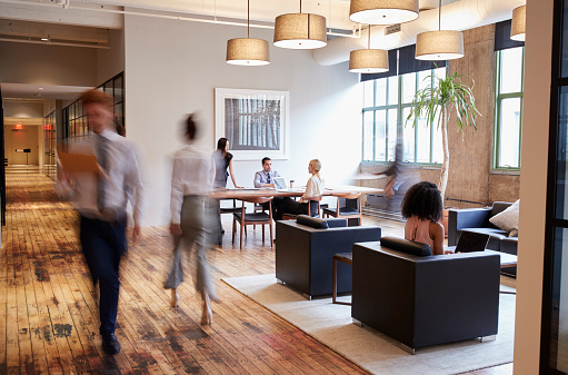 Business people at work in a busy luxury office space