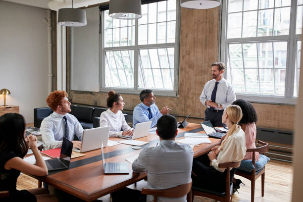 istock Bearded businessman addressing colleagues at a board meeting 904596298
