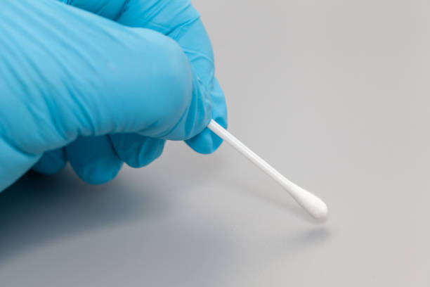 istock Hand in blue glove holding cotton bud 904596308
