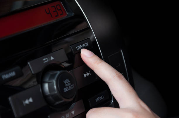istock Woman finger pressing button (USB AUX) detail on a car's dashboard 904598426