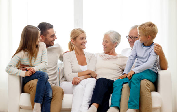 istock happy family sitting on couch at home 904598720