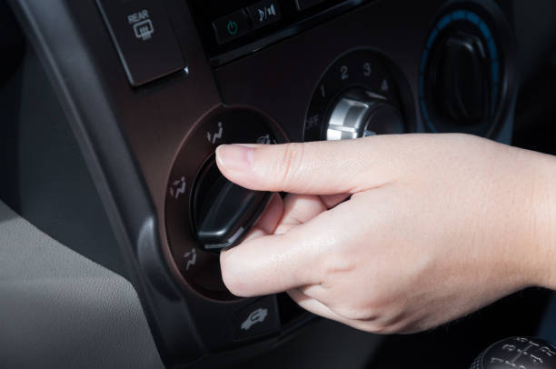 istock hand turning on car air conditioning system 904598734