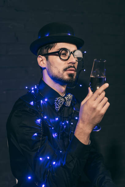 istock man with champagne and christmas lights 904599036