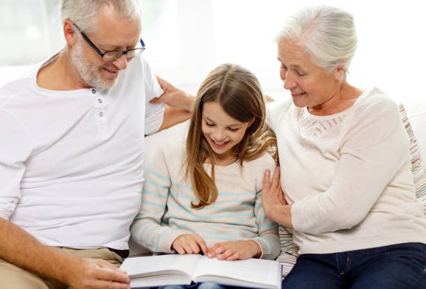 istock smiling family with book at home 904603004