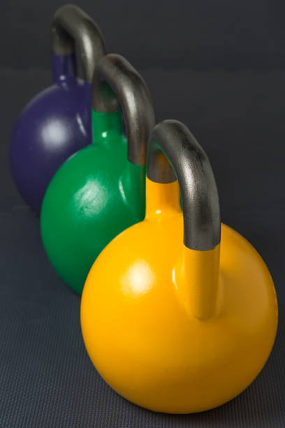 istock Competition kettlebells lined up in a row on a gym floor 904603058