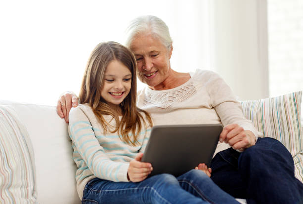 istock smiling family with tablet pc at home 904603438