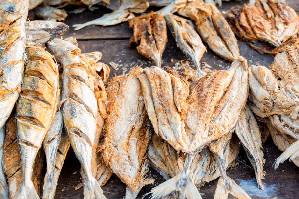 istock Close up sun-dried fish on wooden table 904607664