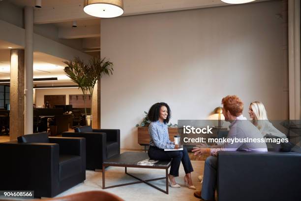 Three Colleagues At A Casual Work Meeting In A Lounge Area Stock Photo - Download Image Now