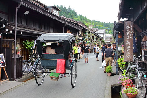 Takayama, Japan - August, 7th of 2017: Traditional jinrikisha in Takayama's old town where very well preserved buildings and whole streets of houses from the Edo Period (1600-1868) can be found.