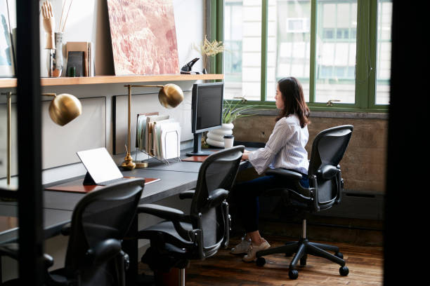 istock Young woman working alone in a compact office 904611242