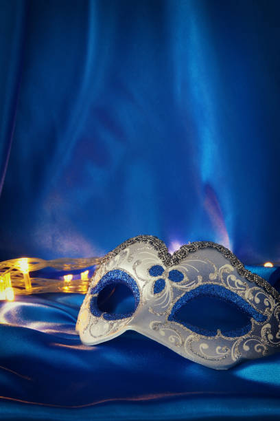istock Image of elegant venetian mask over blue silk background. 904616706