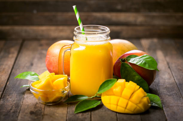 Fresh mango smoothie in the glass stock photo