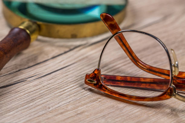 istock Eyeglasses and Magnifying Glass On Wood 904619670