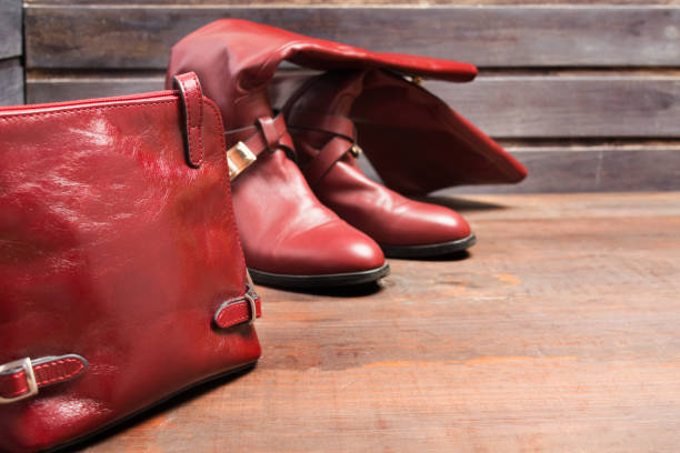 istock Red bag and high boots on wooden background 904623232