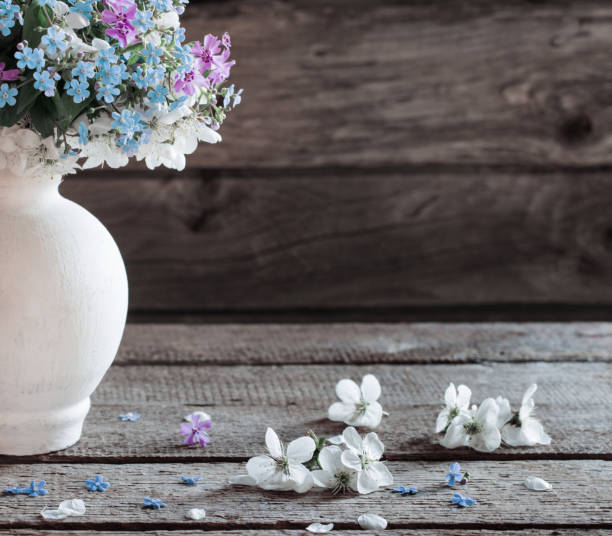 istock spring flowers in vase on dark wooden background 904623798