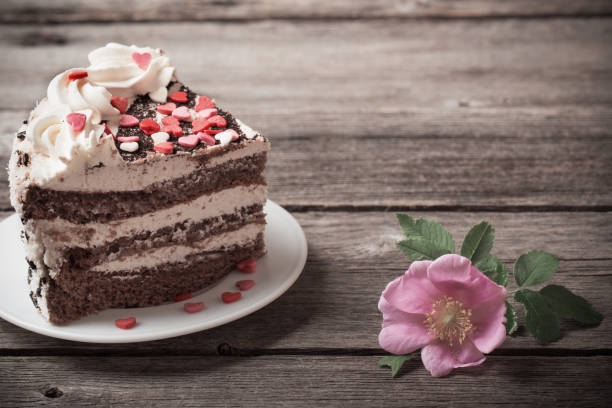 istock chocolate cake with rose on old wooden background 904623818