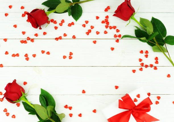 istock Valentine's day . Beautiful red roses, gift and red hearts on white background. top view. Copy space 904638470