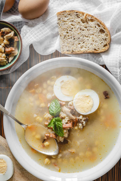 istock Healthy and warming winter soup with rice, carrot, chickpeas, chicken, ham and boiled egg over rustic background. Spanish soup (Puchero Andaluz). Top view. Winter food concept 904639032