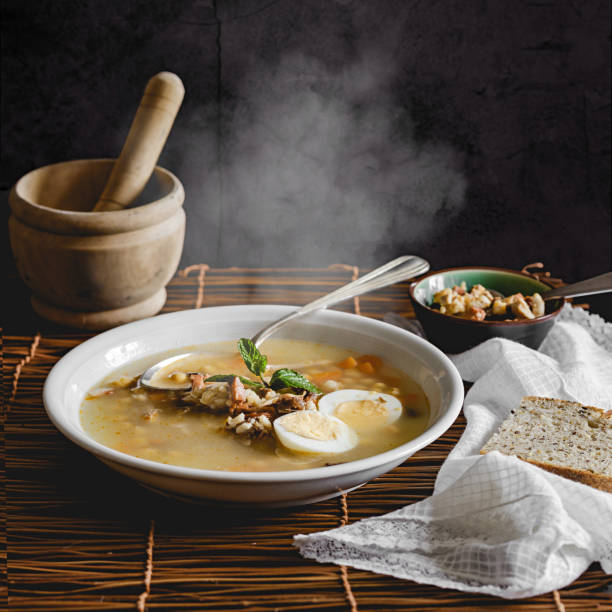 istock Healthy and warming winter soup with rice, carrot, chickpeas, chicken, ham and boiled egg over rustic background. Spanish soup (Puchero Andaluz). Winter food concept 904639038