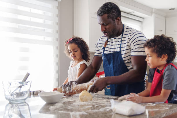 istock Father cooking with kids 904639062