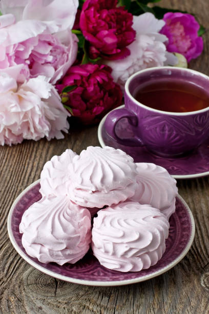 istock Still life with tea cup, zephyr cookies and peonies 904639274