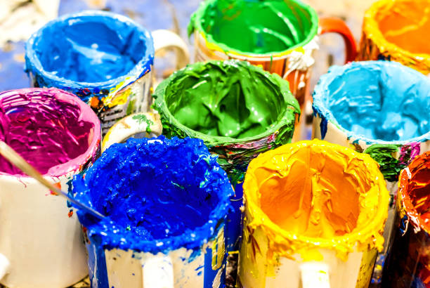 istock Multicolored paints in cans in the workshop 904642160