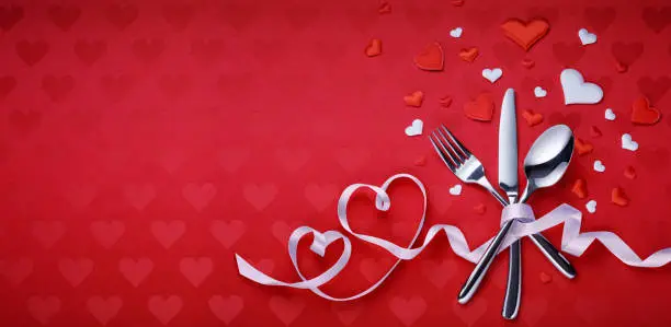 Cutlery With Ribbon On Red Tablecloth