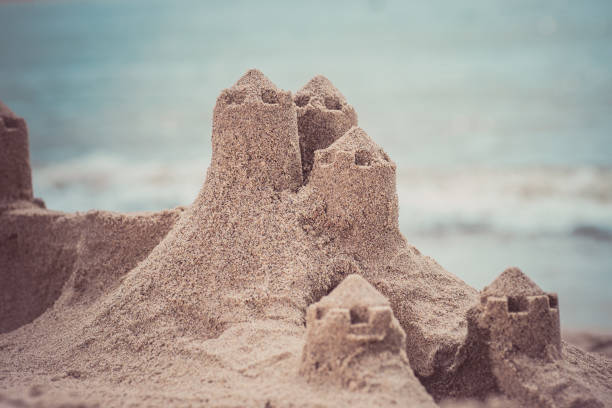 istock Sand castle standing on the beach. Travel vacations concept. 904646612