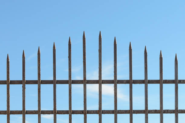 istock Steel fence against the sky 904649706