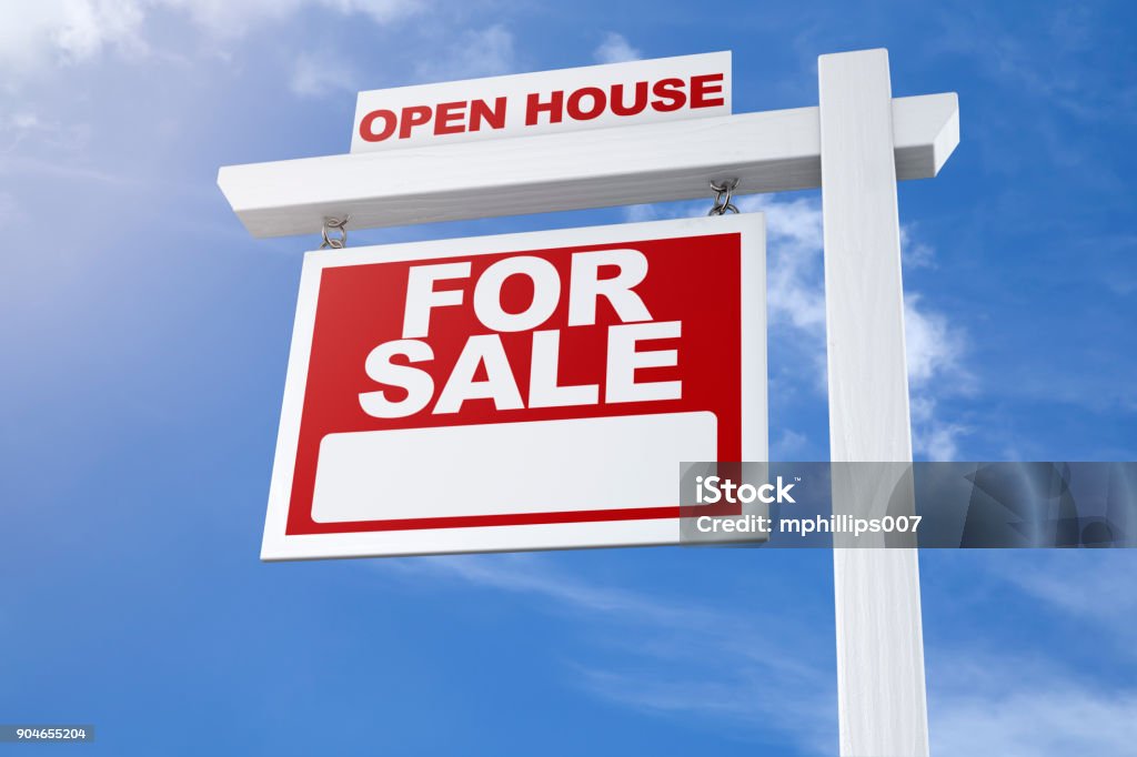 Real Estate Sign For Sale Open House Blue Sky A realtors open house real estate for sale sign against a blue summer sky from a low angle with no people. Sign Stock Photo